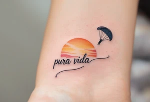 Cursive “Pura Vida” trailing behind a paragliding silhouette against a sunset gradient of yellow, orange, and magenta. tattoo idea
