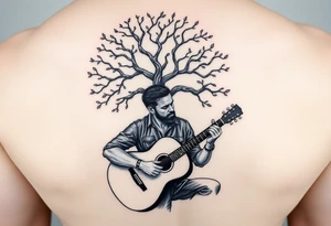 Man playing acoustic guitar underneath tree of life tattoo idea