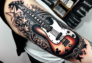 Tattoo full left arm with a collage of a bass guitar, mickey mouse symbol, a medicine caduceus, two stars tattoo idea