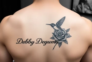A tattoo on the forearm with the name Debby Deguzman with a humming bird and a rose tattoo idea
