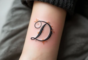 Elegant Script D – A flowing cursive letter D in black ink with delicate orange filigree details wrapping around the curves. tattoo idea