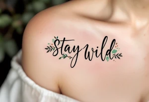 "Stay Wild" in handwritten brush script, black ink with subtle watercolor splashes in earthy greens and browns, giving it a free-spirited, nature vibe. tattoo idea