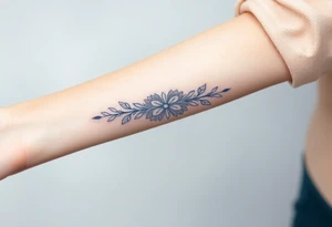 A lace ribbon around the forearm, with fine embroidery-inspired details tattoo idea
