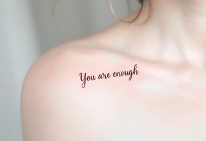 “You are enough” in dusty rose with a faint watercolor background of pastel blues and pinks. tattoo idea