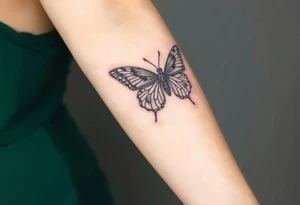 A black lace butterfly with intricately patterned wings, featuring subtle silver highlights tattoo idea