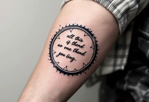 A motivational quote wrapped around a bike wheel, in elegant cursive script with subtle navy blue accents. tattoo idea