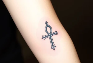 A Hand Holding an Ankh with a Name Written Inside(only red , blue and black are possible colors) tattoo idea