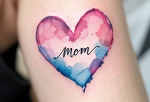 A watercolor heart in pink and blue with the word “Mom” scripted across it in elegant cursive. tattoo idea