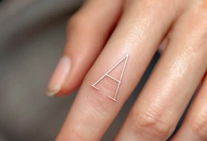 A minimalist outline "A" in soft gray with a blush pink inner fill on a finger. tattoo idea