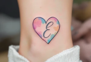 A soft pastel heart outline with a handwritten letter "E" in light grey ink, creating a delicate and airy aesthetic. tattoo idea