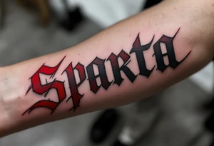 The word “SPARTA” written in Gothic script across the forearm, half in hockey red, half in football maroon. tattoo idea