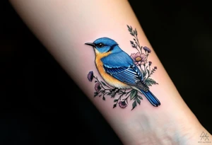 Puffy bluebird surrounded by wild flowers tattoo idea