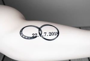 two wedding rings as symbol of infinity with date 22. 7. 2018 tattoo idea