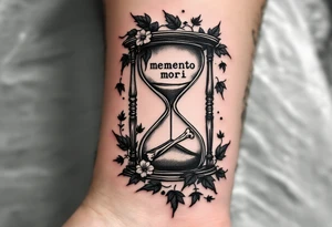 A grayscale hourglass with bones slowly slipping through, framed by dark ivy leaves and "memento mori" in faint white ink across the glass. tattoo idea