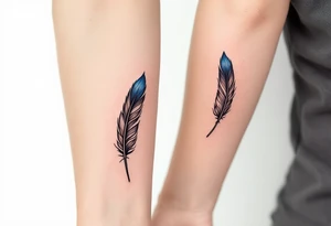 Two matching man and woman black feather tattoos with blue tips. tattoo idea