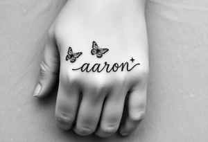 a hand tattoo with the name aaron, add some butterflies and a semicolon tattoo idea