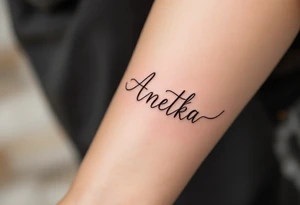 Anetka written on a flowing ribbon, shaded in soft rose gold tones. tattoo idea