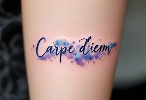 "Carpe Diem" in dark navy ink, placed over a soft watercolor galaxy in shades of purple and blue. tattoo idea