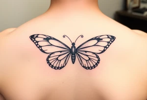 dainty butterfly with swirls coming from both wings tattoo idea