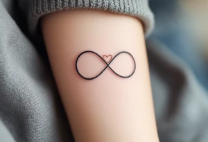 A simple gray infinity outline encircling a small rose-gold heart. tattoo idea