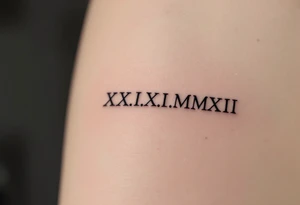 Elegant XXI.XI.MMXII in dark gray ink styled with subtle shadowing for a stone-carved effect. tattoo idea