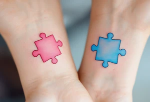 Interlocking puzzle pieces in soft pink and muted blue on the inner wrists symbolize how perfectly you fit together. tattoo idea