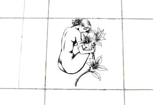 A simple tile floor. On top of the tile A curled figure with a lily next to her tattoo idea