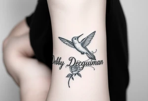 A tattoo on the forearm with the name Debby Deguzman with a humming bird and a rose tattoo idea