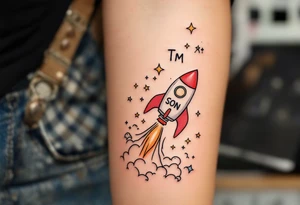 A playful rocket ship blasting off in vibrant reds and oranges, trailing stars that form the son’s initials TM in the sky. tattoo idea