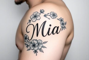 The name Mia, surrounded by flowers and shamrocks tattoo idea
