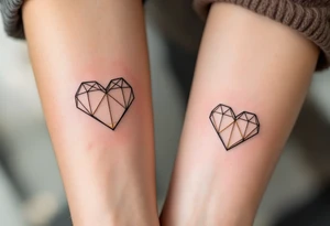 A pair of geometric hearts in black and gold ink etched into the forearms, symbolizing balance and unity. tattoo idea