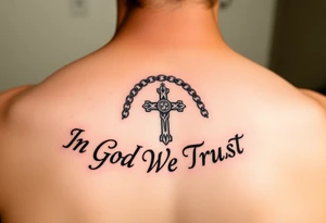 Rosary surrounded by the words "In God We Trust" tattoo idea