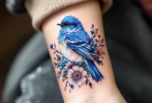 Puffy bluebird surrounded by wild flowers tattoo idea