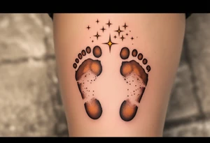 Warm brown and cream footprints of Michaela, with tiny twinkling stars above, representing her bright, guiding light. tattoo idea