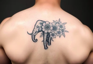 Elephant with flowers on the arm tattoo idea