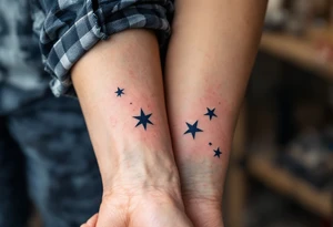 Matching man woman tattoo of nautical stars, the father’s in dark navy blue on the chest, the child’s smaller in light blue on the ankle. tattoo idea