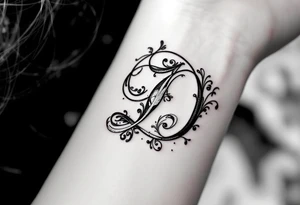 Elegant Script D – A flowing cursive letter D in black ink with delicate silver filigree details wrapping around the curves. tattoo idea