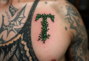 A leaf-textured "T" in forest green with tiny vines wrapping around it. tattoo idea