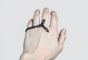Gothic chains wrapped around outline of hand on the the index finger and connected to the thumb tattoo idea