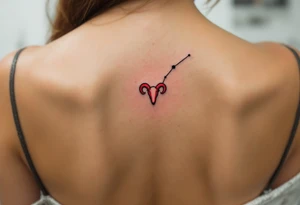 This minimalist Aries tattoo in black ink outlines the constellation with a tiny red ram symbol at its core. tattoo idea