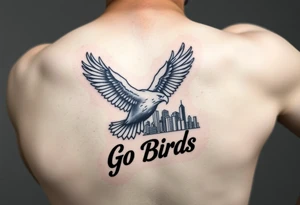 Tattoo On upper bicep 
Philadelphia Eagle classic bird flying over Philadelphia city skyline with the words Go Birds in bubble letters under it tattoo idea