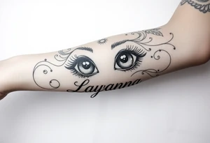 Baby eyes with the name layanna at the bottom of it tattoo idea