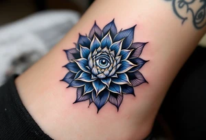 A deep indigo lotus flower with a central eye and subtle gold highlights around the petals. tattoo idea