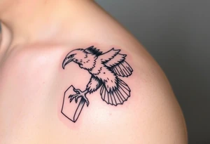 big eagle with paper in its claws tattoo idea