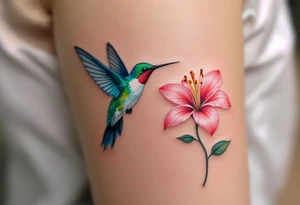 One partner has a hummingbird in flight with green and blue feathers, the other a lily in soft pink tones it’s flying toward. tattoo idea