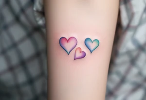 Three delicate hearts in a watercolor gradient of pink, lavender, and teal, fading into each other to symbolize everlasting love. tattoo idea