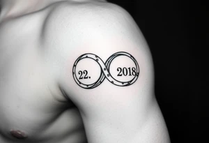 two wedding rings as symbol of infinity with date 22. 7. 2018 tattoo idea
