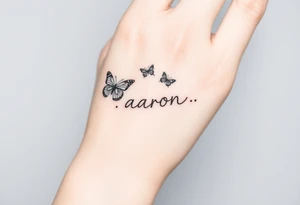 a hand tattoo with the name aaron, add some butterflies and a semicolon tattoo idea