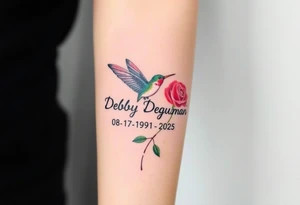A tattoo on the forearm with the name Debby Deguzman with a humming bird and a rose 08-17-1961 to 05-29-2025 tattoo idea