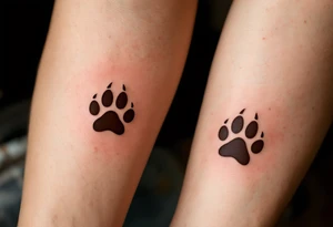 Coordinated matching paw prints in rich brown ink reflect a shared love for pets and loyalty. tattoo idea